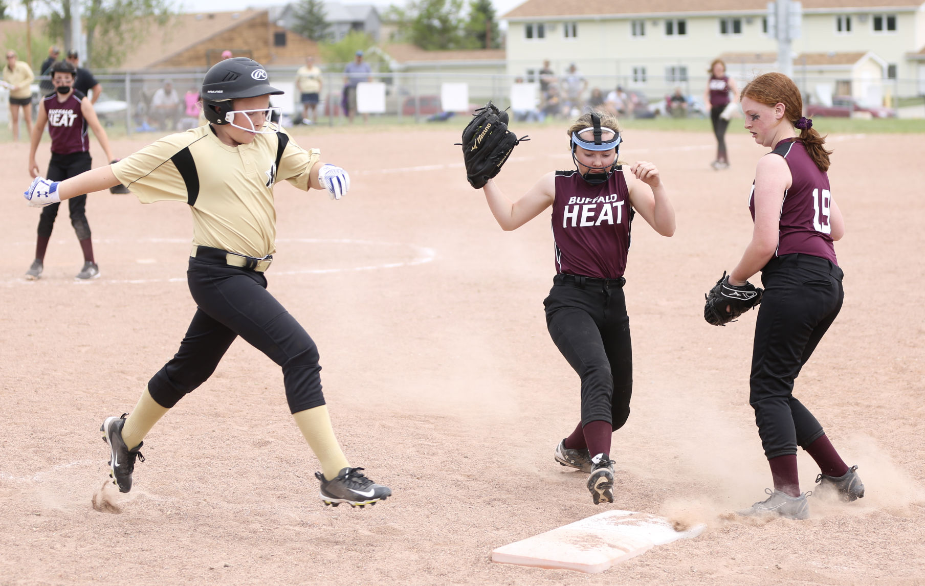 First baseman Kolby Packard stretches to beat Sheridan’s Sydney Murner to first base